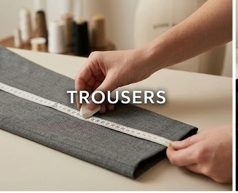 Grey trousers being measured for an alteration